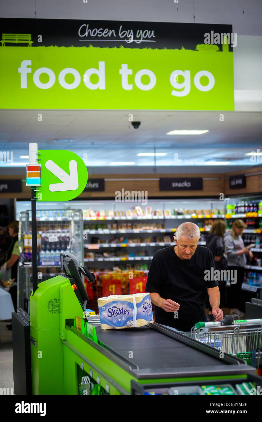 man using a self-service till at an asda supermarket in 2014 Stock Photo