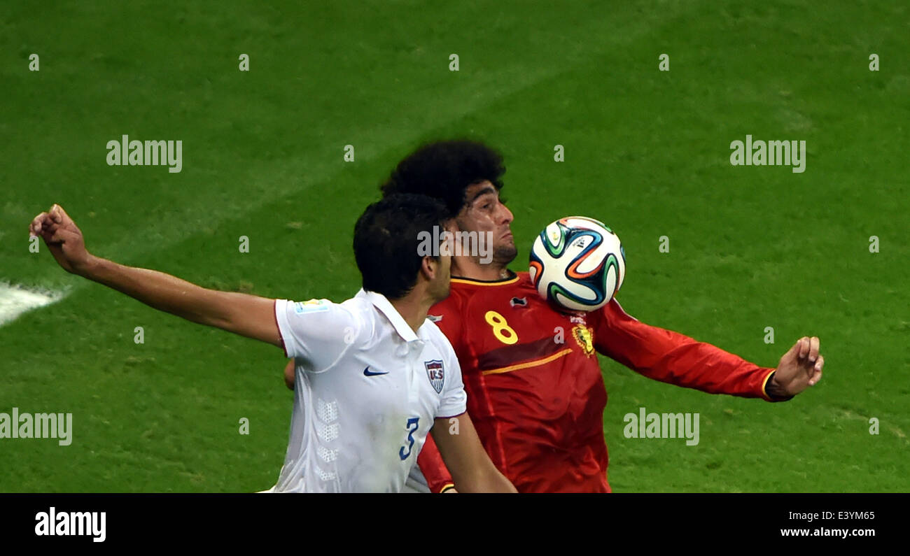 Salvador, Brazil. 1st July, 2014. Belgium's Marouane Fellaini (R) vies with Omar Gonzalez of the U.S. during a Round of 16 match between Belgium and the U.S. of 2014 FIFA World Cup at the Arena Fonte Nova Stadium in Salvador, Brazil, on July 1, 2014. Belgium won 2-1 over the U.S. after 120 minutes and qualified for quarter-finals on Tuesday. Credit:  Guo Yong/Xinhua/Alamy Live News Stock Photo