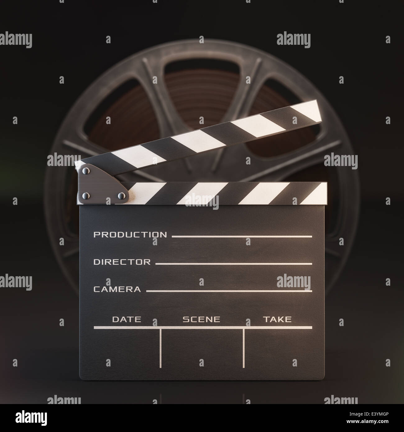 Clapperboard in the foreground with a roll of film in the background. Stock Photo