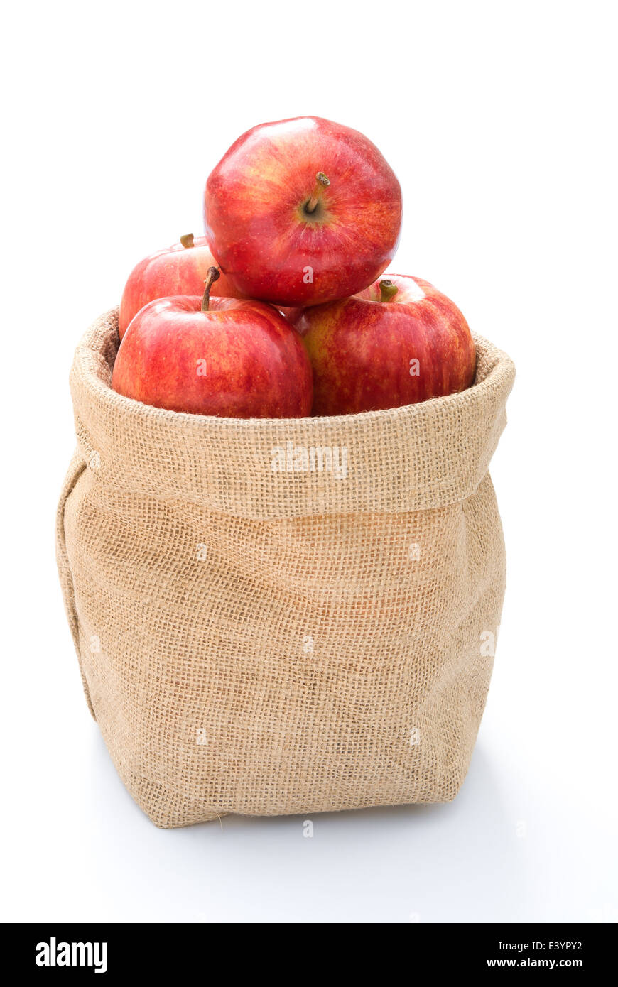 fresh apples in gunny bag on white Stock Photo