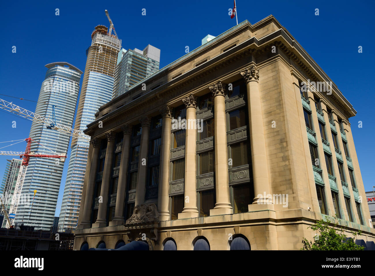 Historic Toronto Harbour Commission building originally on Lake Ontario surrounded by new highrise condo towers Stock Photo