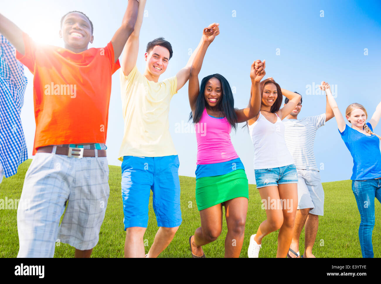 Multi-Ethnic Teenagers Outdoors Holding Hands Celebrating Stock Photo