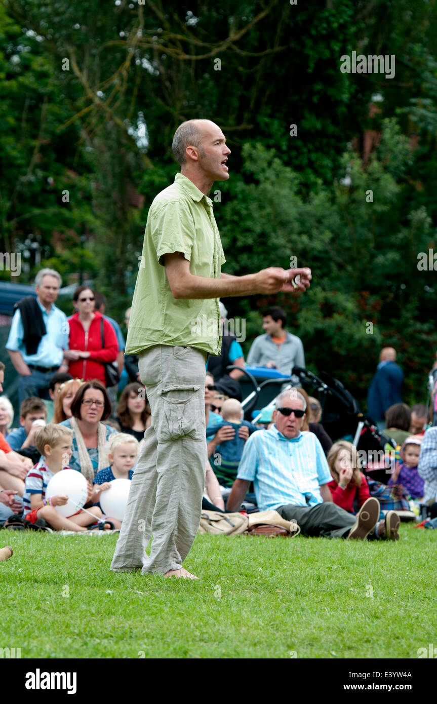 A man conducting a community choir at Leamington Peace Festival, UK Stock Photo