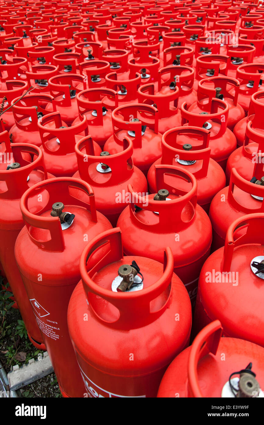 A pattern of red gas bottles, waiting at a depot. Stock Photo