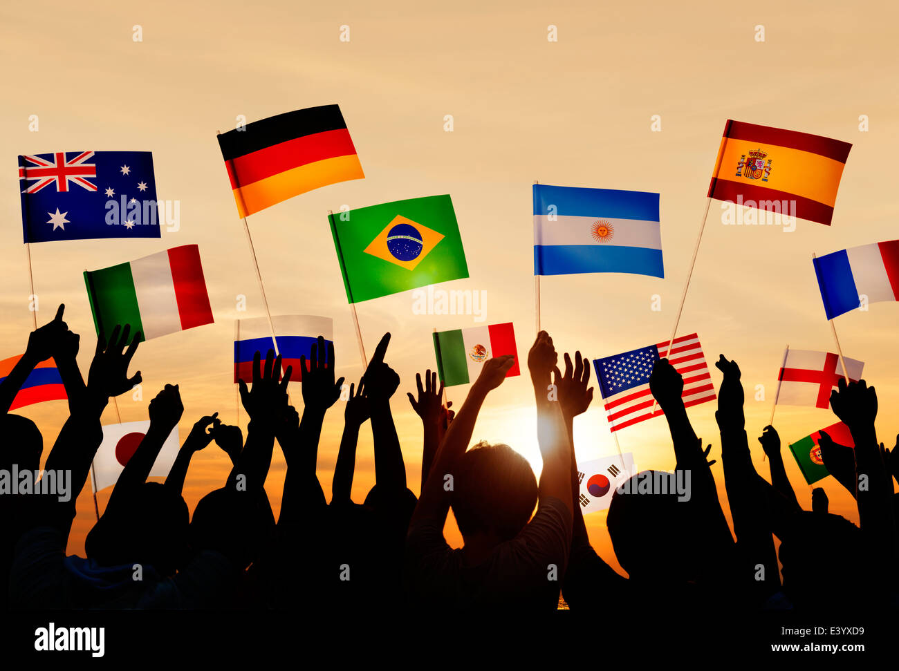 Silhouettes of People Holding Flags From Various Countries Stock Photo