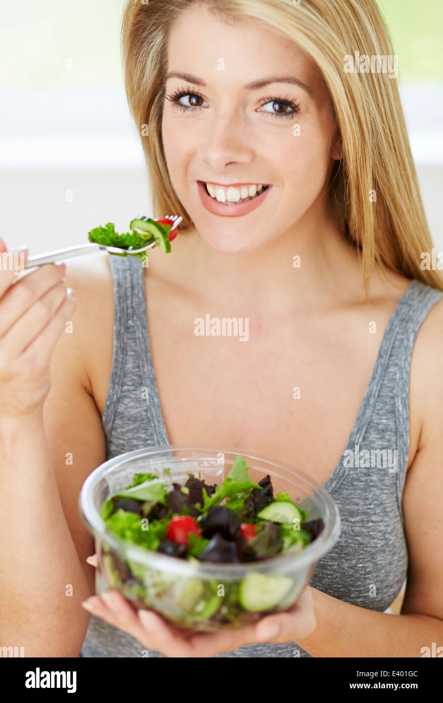 Beautiful girl eating healthy salad Stock Photo