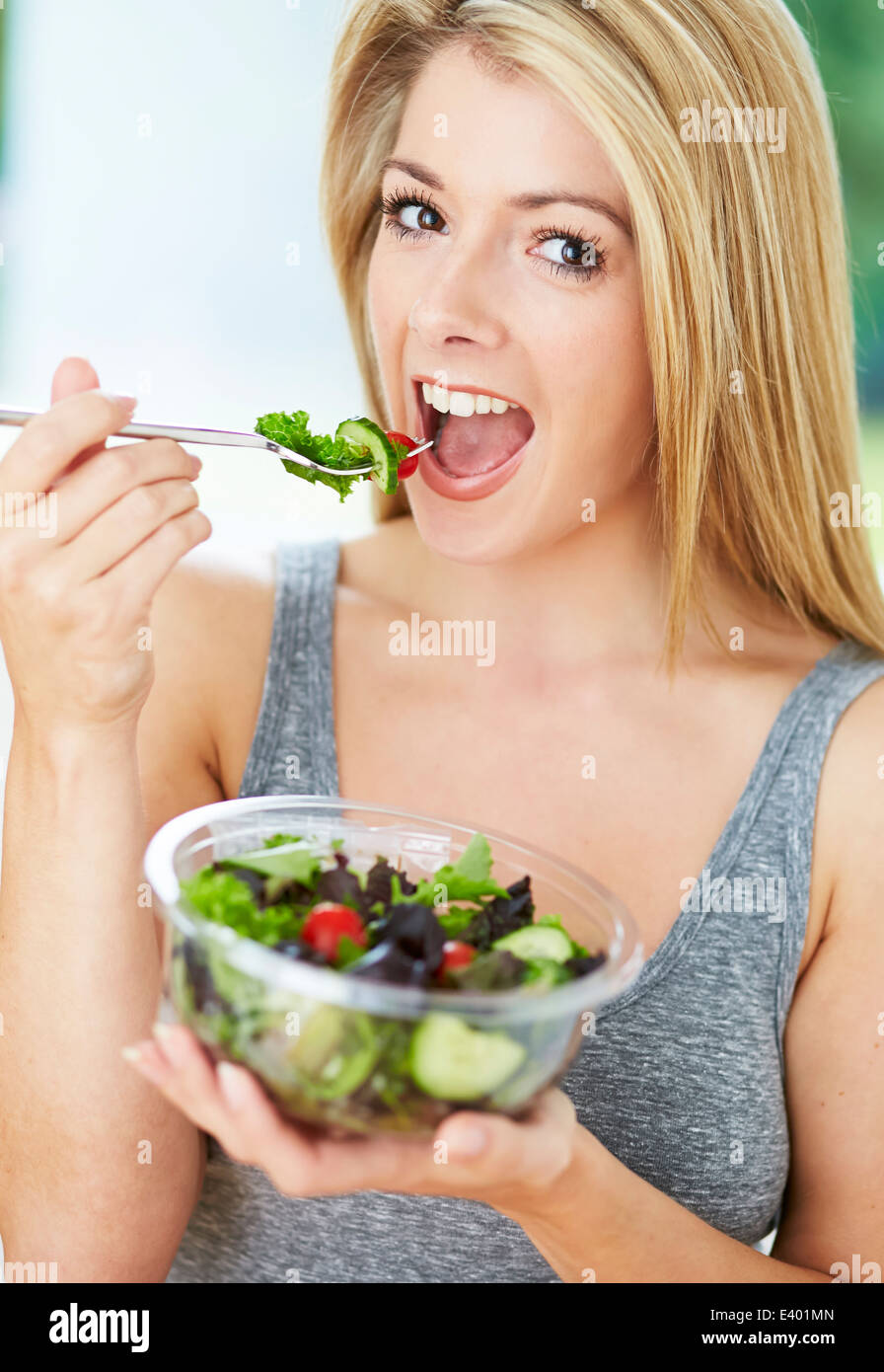Beautiful girl eating healthy salad Stock Photo