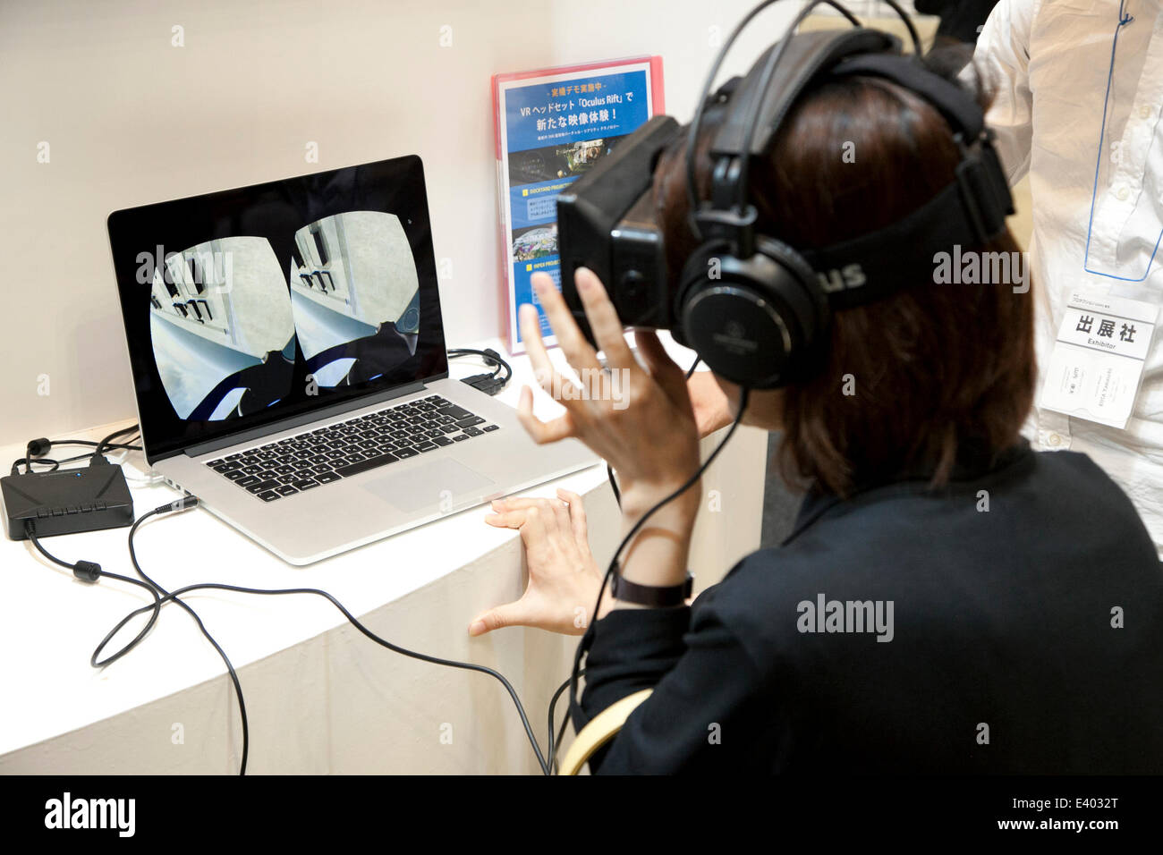 Tokyo, Japan. 2nd July, 2014. A woman tests the 'Oculus Rift' simulator at the Tokyo International Book Fair in Tokyo Big Sight on July 2, 2014. The 21st edition of Tokyo International Book Fair (TIBF) is Japan's largest publishing event, brings together publishing companies from 25 countries and 65,000 visitors, shows the latest electronic book technologies and services. The TIBF is open from July 2 to July 5. Credit:  Rodrigo Reyes Marin/AFLO/Alamy Live News Stock Photo