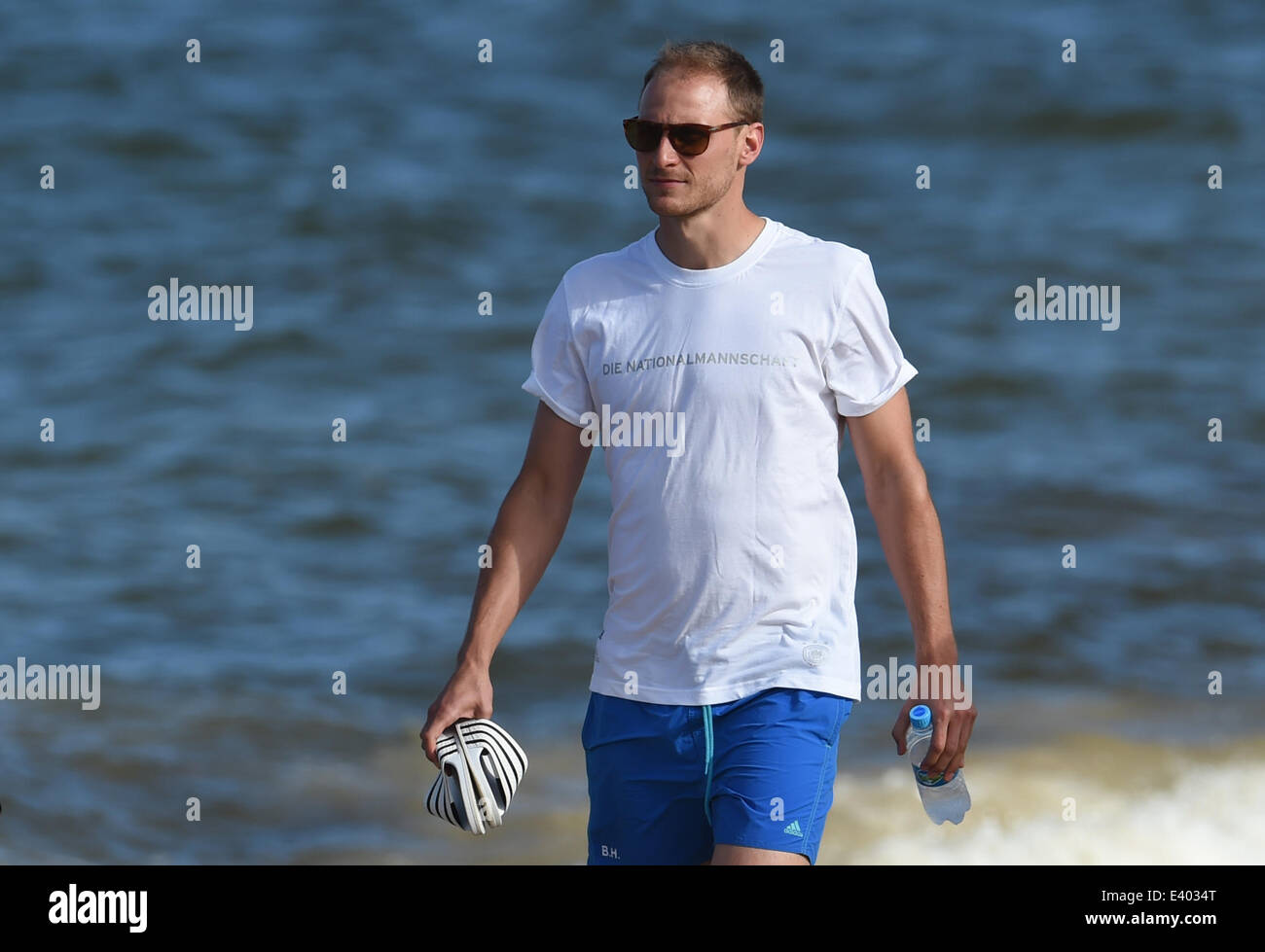 Santo Andre, Brazil. 01st July, 2014. German soccer player Benedikt Hoewedes walks along the beach near the team hotel in Santo Andre, Brazil, 01 July 2014. The FIFA World Cup 2014 takes place in Brazil from 12 June to 13 July 2014. Photo: Andreas Gebert/dpa/Alamy Live News Stock Photo