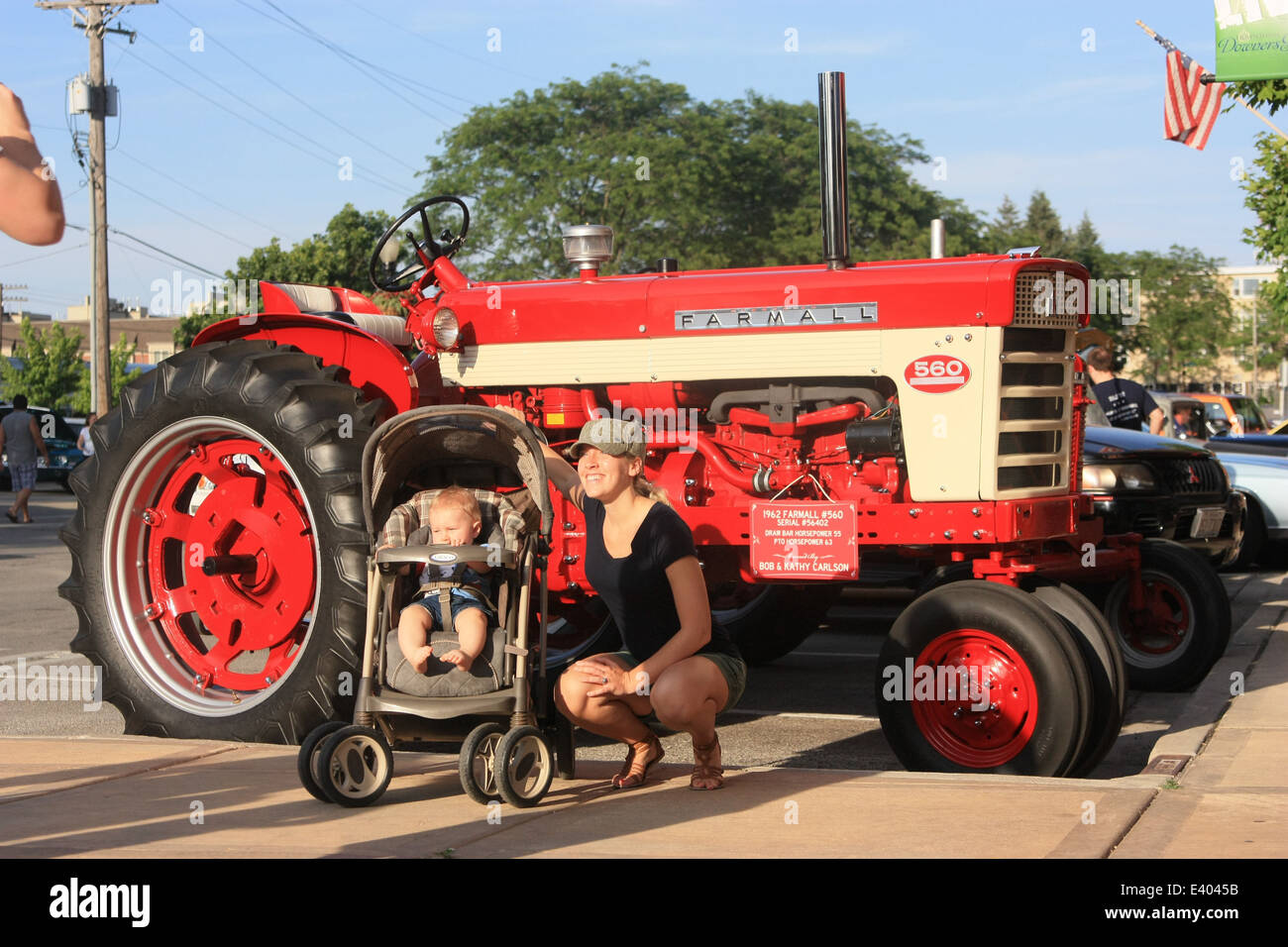 Downers Grove (Illinois) Car Show, June 09, 2012, 9:17 AM. FARMALL tractor and a young family Stock Photo