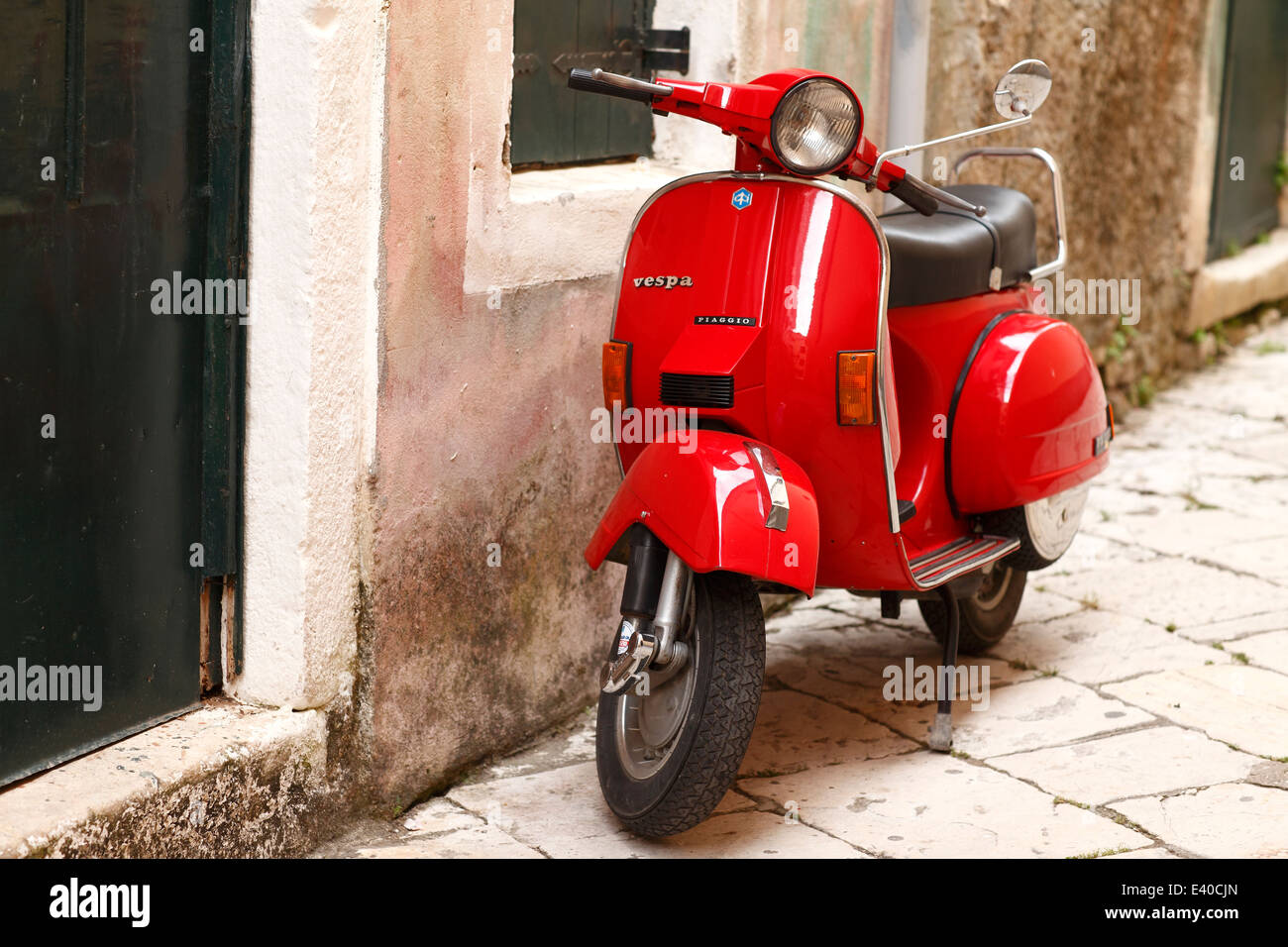 Greece, Ionic Islands, Corfu, red old Vespa scooter parking in front of  house Stock Photo - Alamy