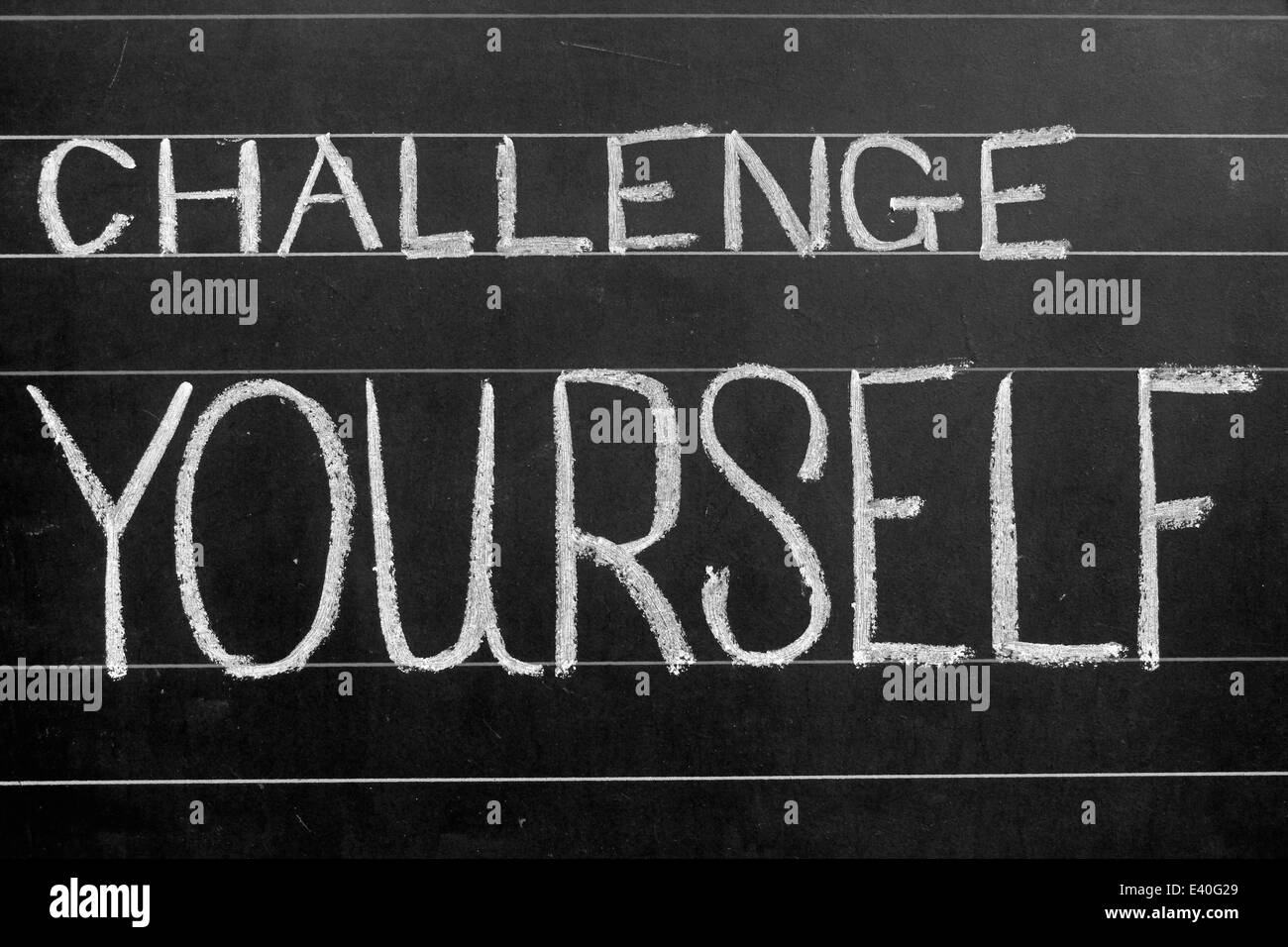 challenge yourself phrase handwritten on black chalkboard Stock Photo