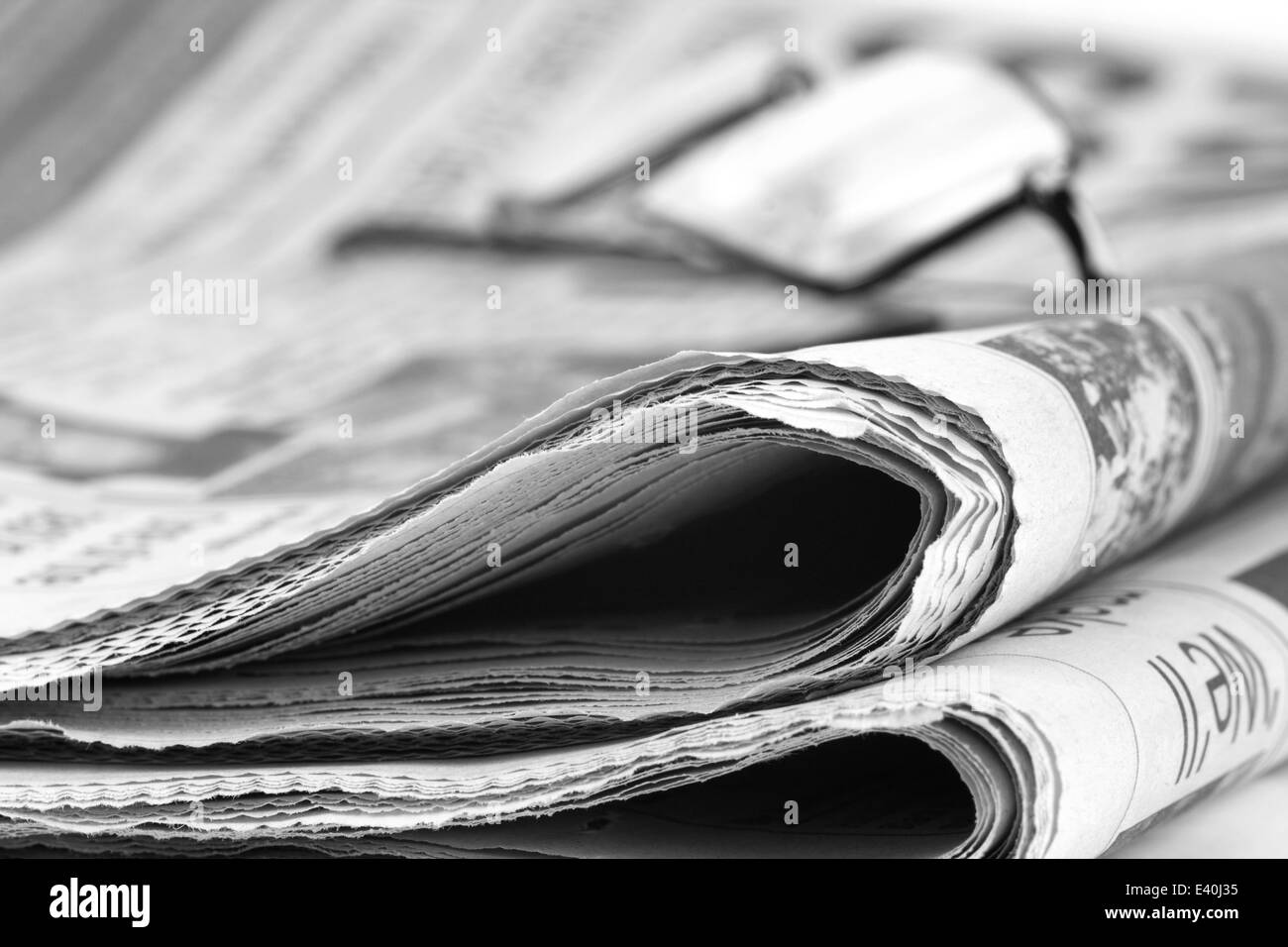 Newspaper folded up with specs Stock Photo
