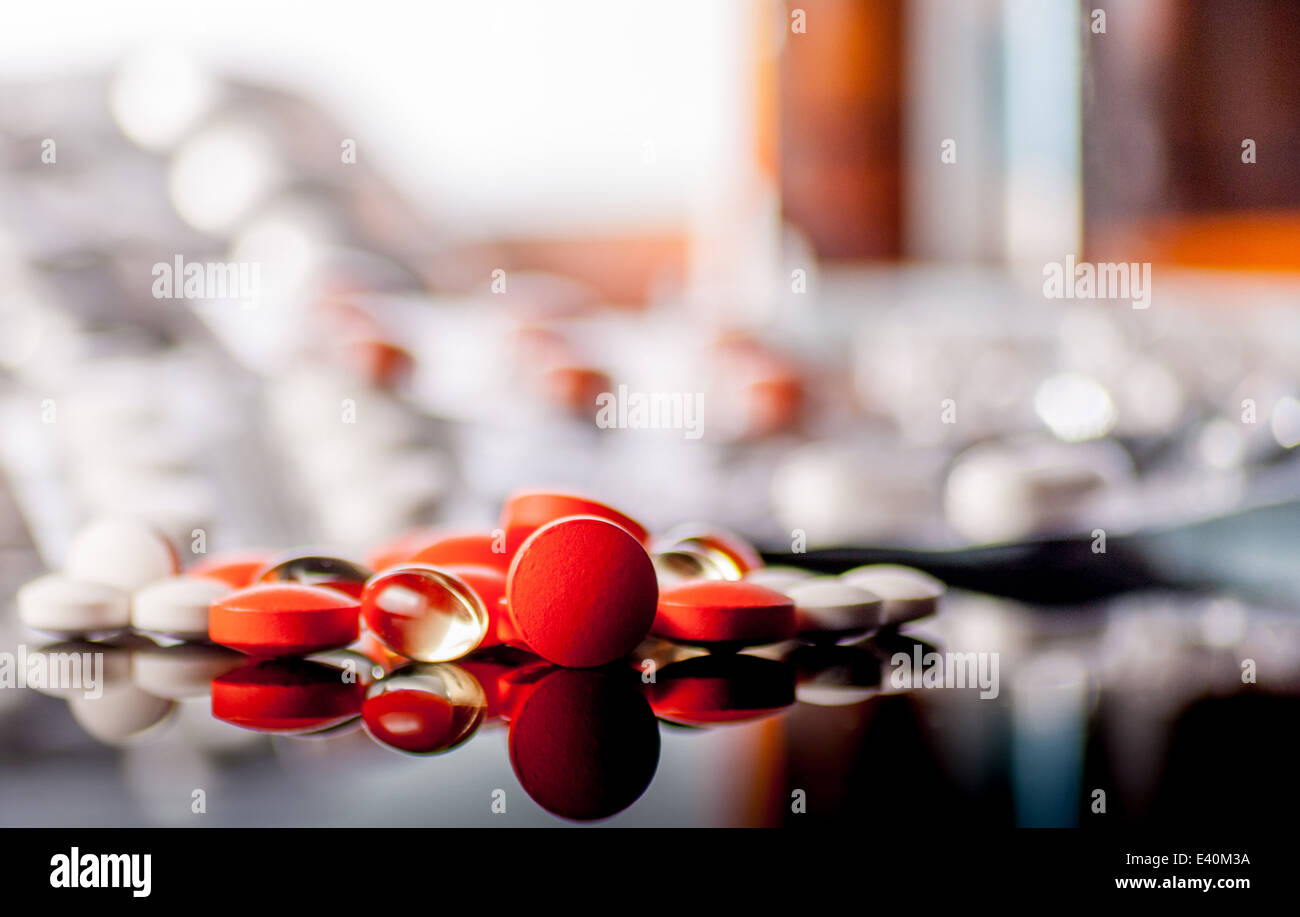 Colorful tablets or pills on reflect background Stock Photo
