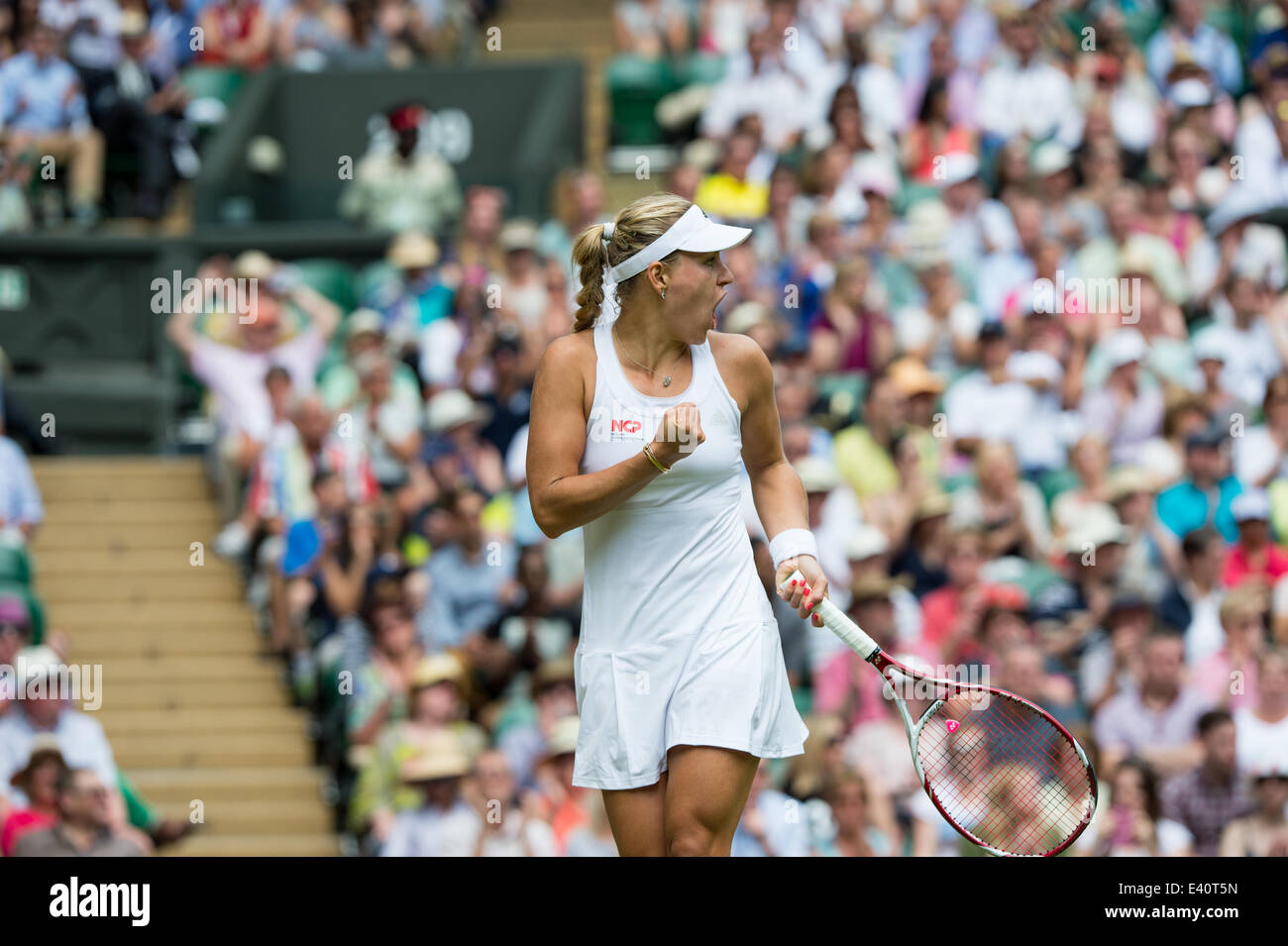 Wimbledon, London, UK. 1st July, 2014. Tennis: Wimbledon Championship 2014, Angelique Kerber of Germany celebrates during her Ladies' Singles fourth round match against Maria Sharapova of Russia on day eight of the Wimbledon Lawn Tennis Championships at the All England Lawn Tennis and Croquet Club at Wimbledon on July 1, 2014, London, England. Credit:  dpa picture alliance/Alamy Live News Stock Photo