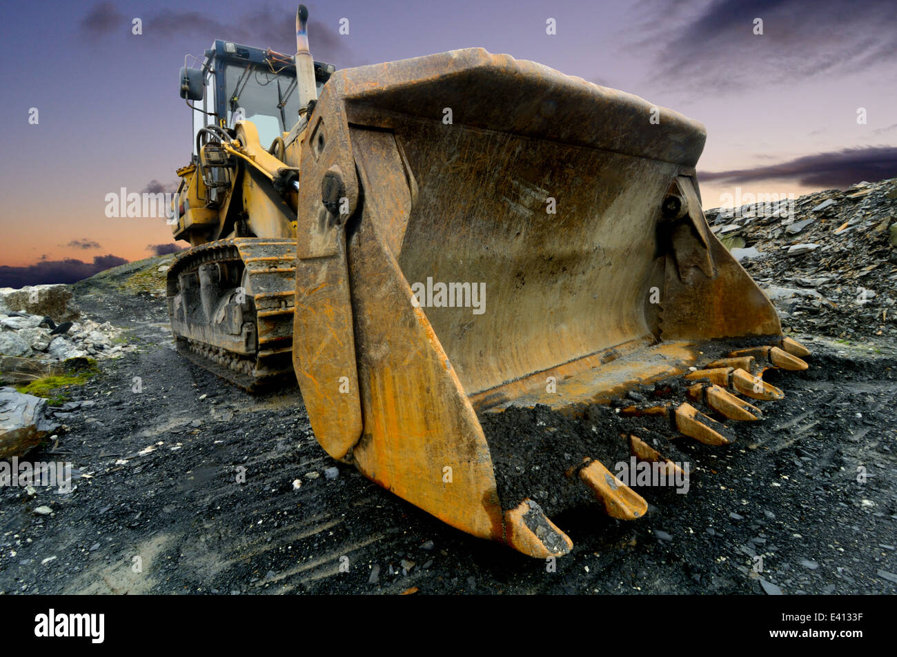 Yellow Power Shovel In The Dirt Spotted In A Quarry Stock Photo
