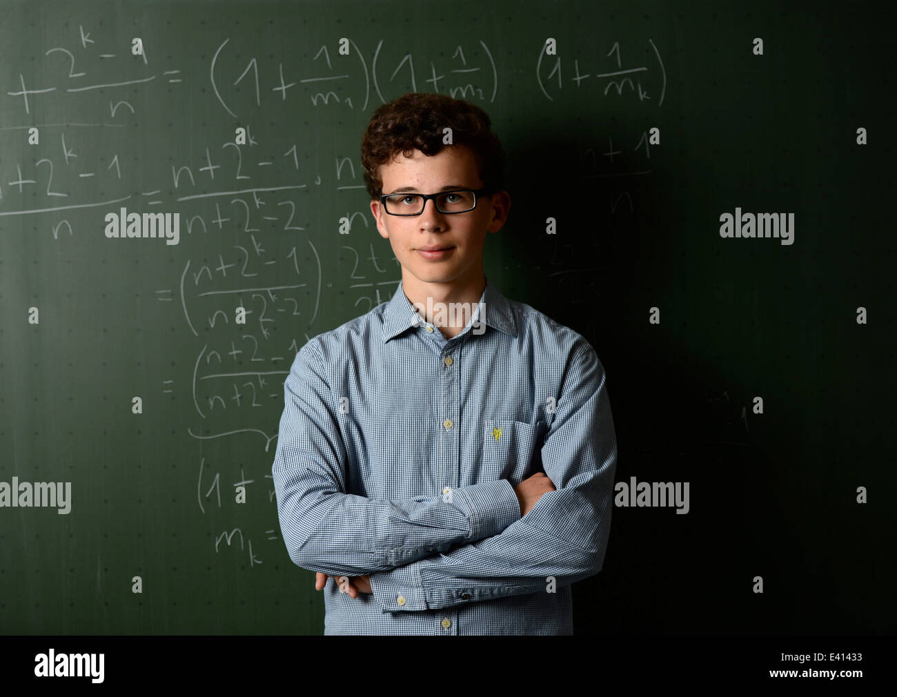 Pupil Adrian Riekert stands in front of a chalk board in a classroom of  Johannes Brahms school in Pinneberg, Germany, 25 June 2014. Riekert is one  of six German participants of the