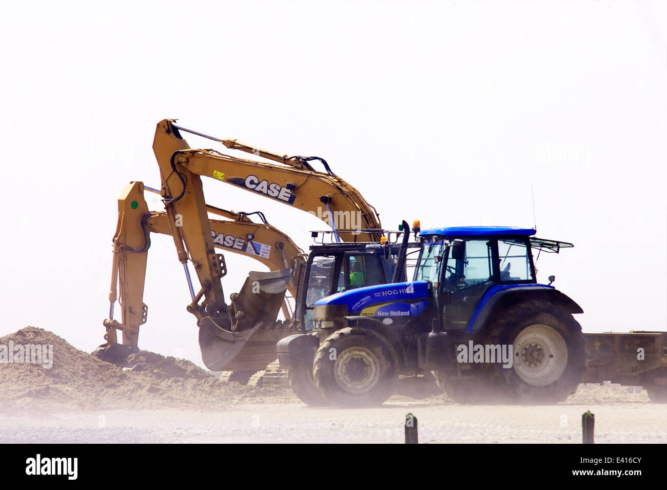 Tractor and excavators working on beach Stock Photo Alamy