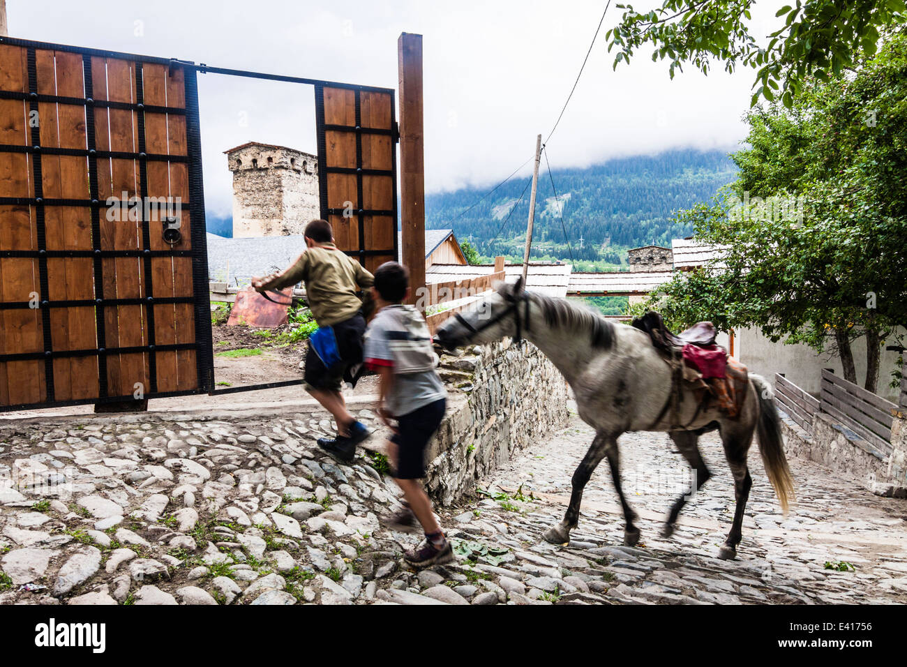 Georgian teens with horse in Mestia, Svaneti, Georgia Stock Photo