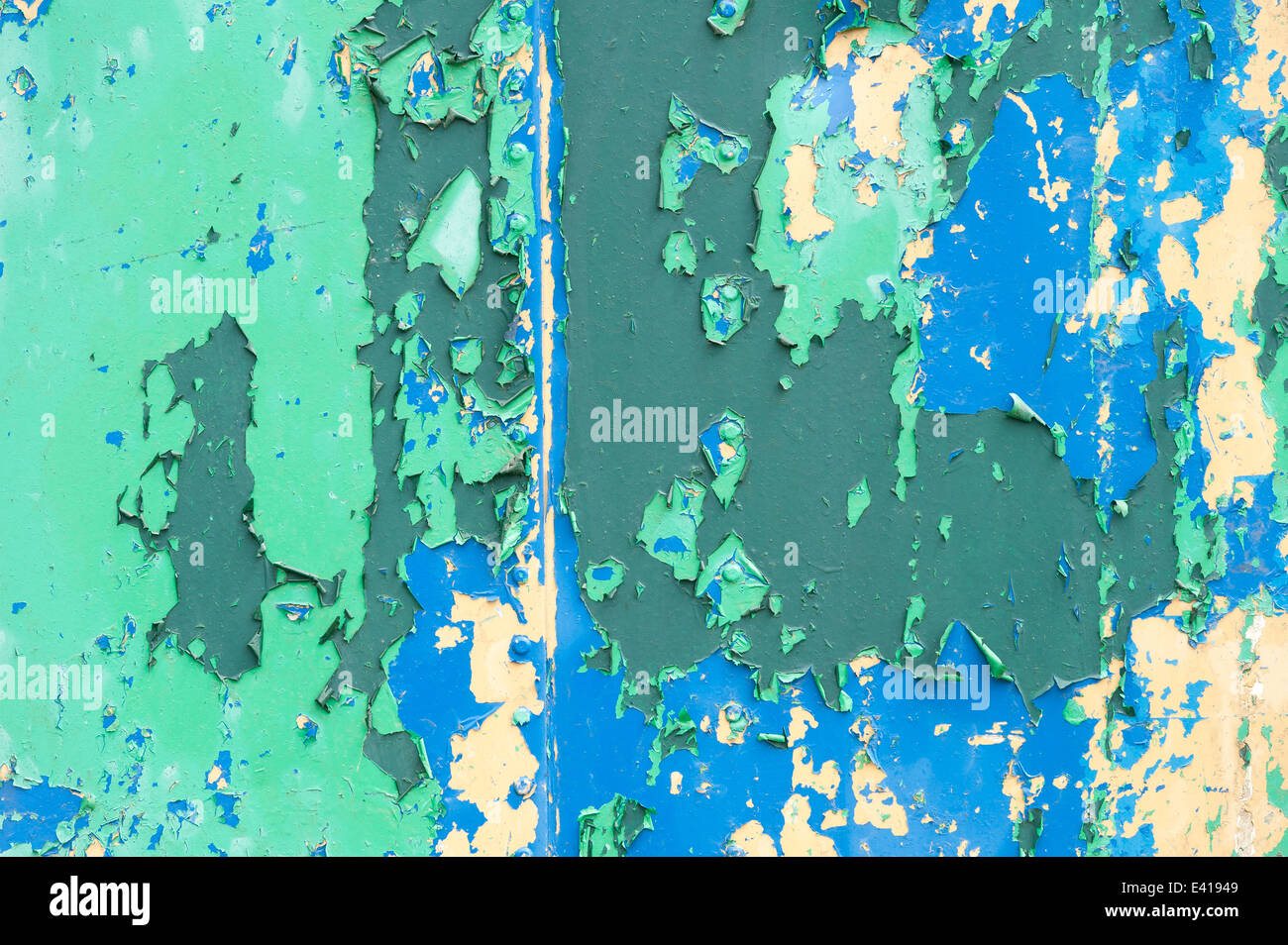 peeling gloss matte emulsion paint and graffiti on steel iron wall old