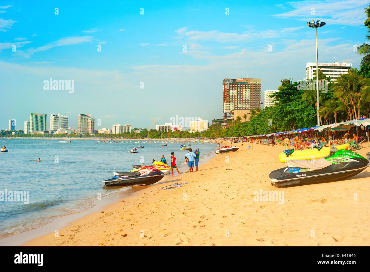 People walking along the beach in Pattaya, Thailand. Stock Photo