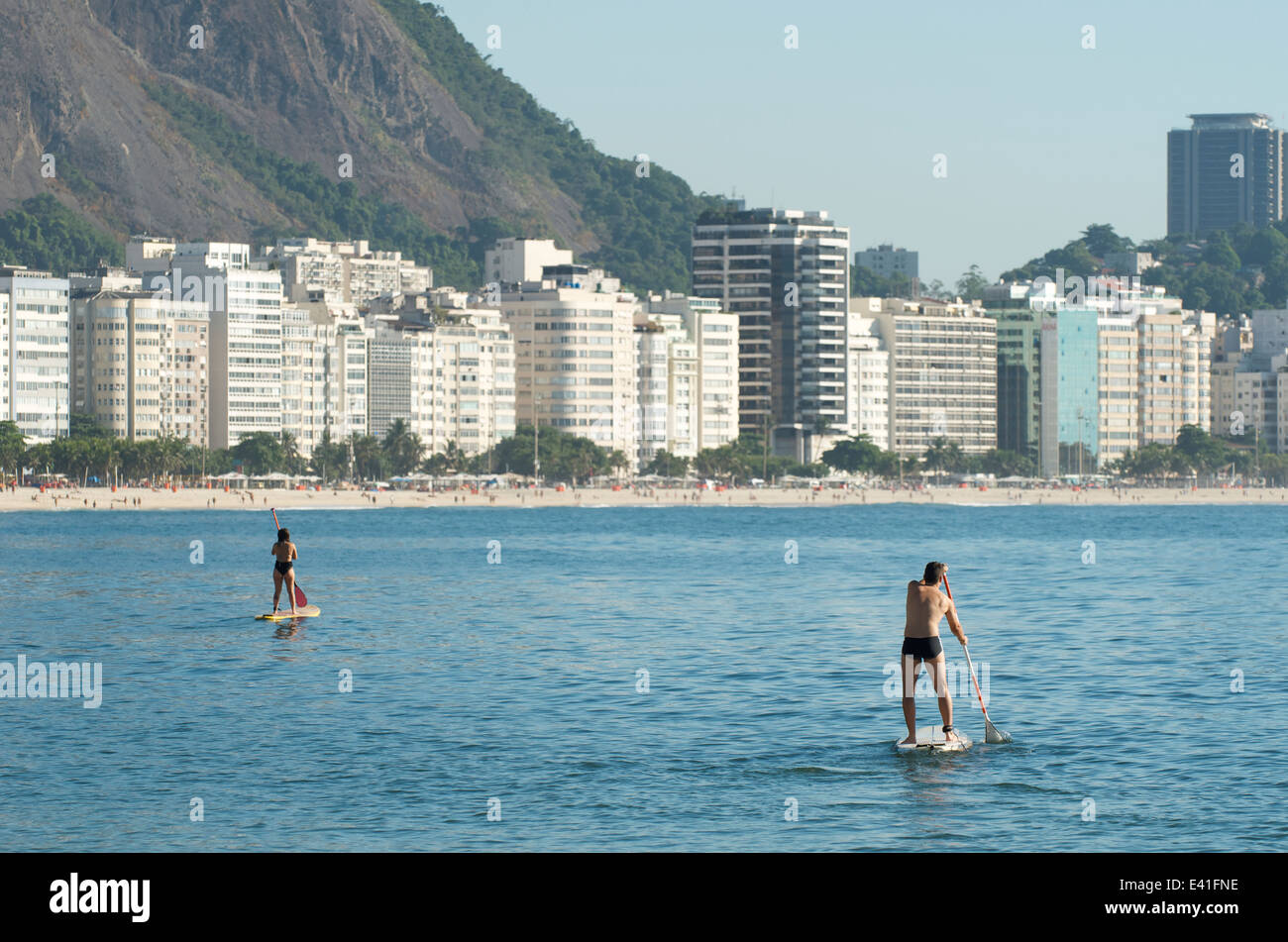Stand up paddle surfers on calm seas at Copacabana Beach Rio de Janeiro Brazil Stock Photo