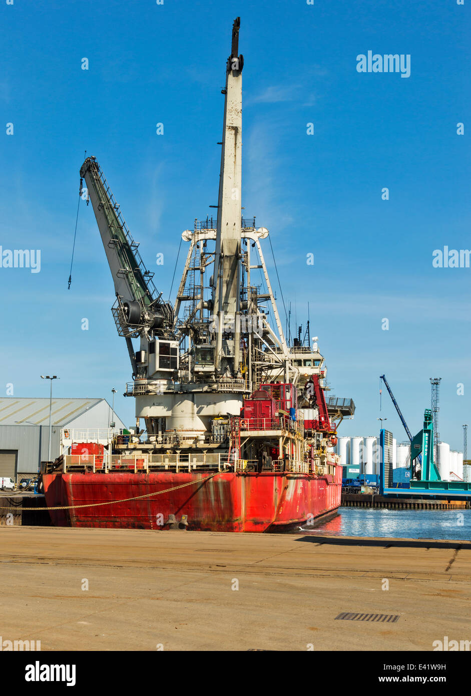 NORTH SEA OIL VESSEL WITH LARGE CRANES BERTHED IN ABERDEEN HARBOUR SCOTLAND Stock Photo