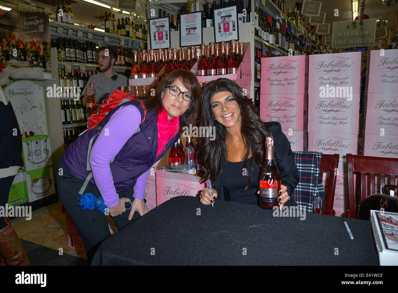 Teresa Guidice  and Joe Giudice sign bottles for her Fabellini line of drinks at the Bayway World of Liquors in Elizabeth New Jersey  Featuring: Teresa Guidice,Susan Lazor Where: Manhattan, New York, United States When: 29 Dec 2013 Stock Photo