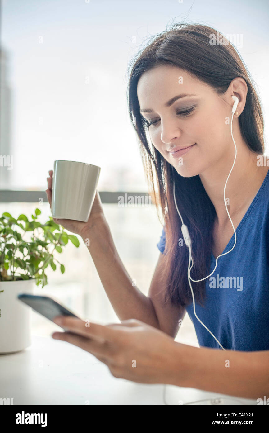 Young woman listening to music on smartphone Stock Photo