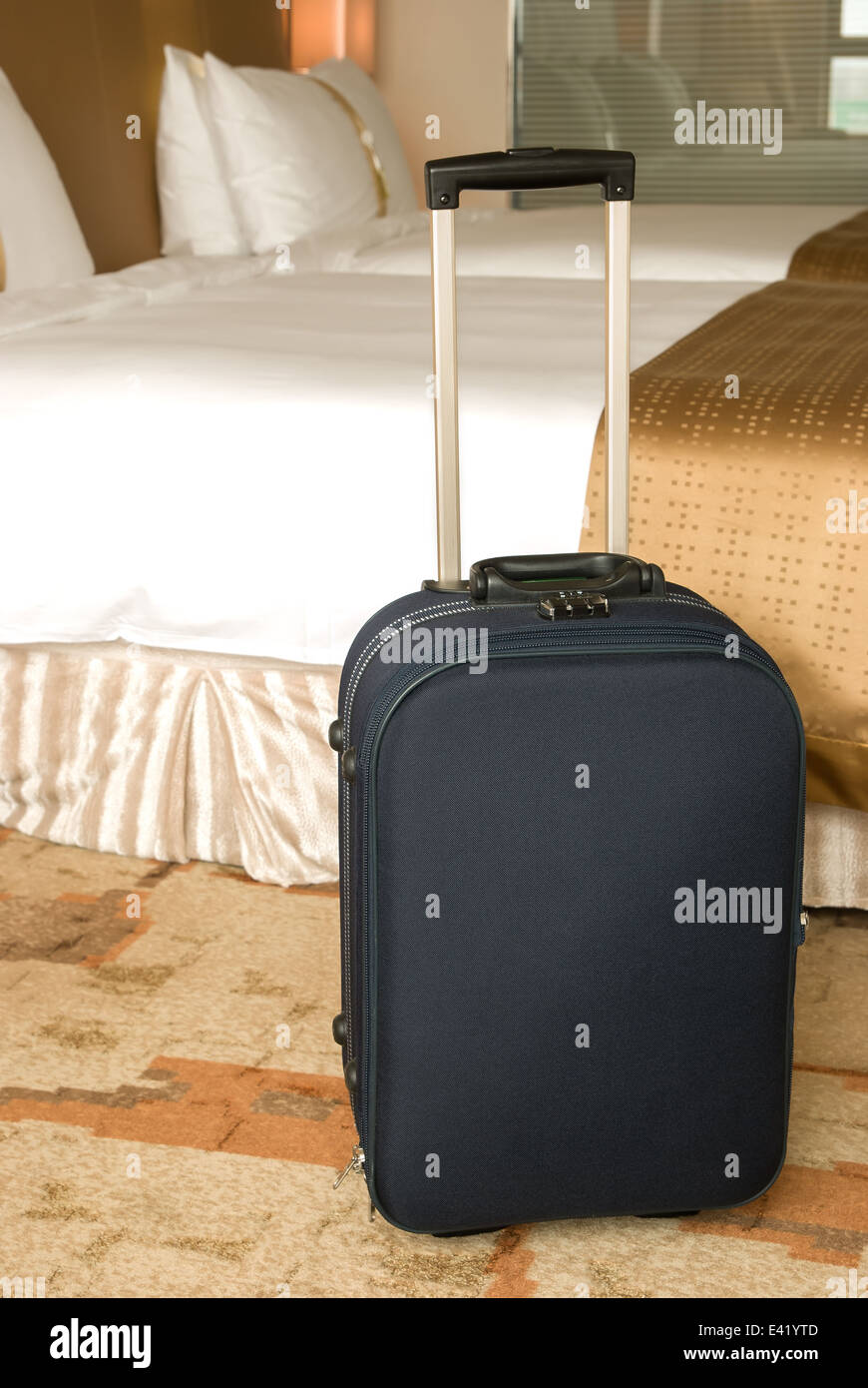 suitcase stands up inside a hotel room Stock Photo Alamy