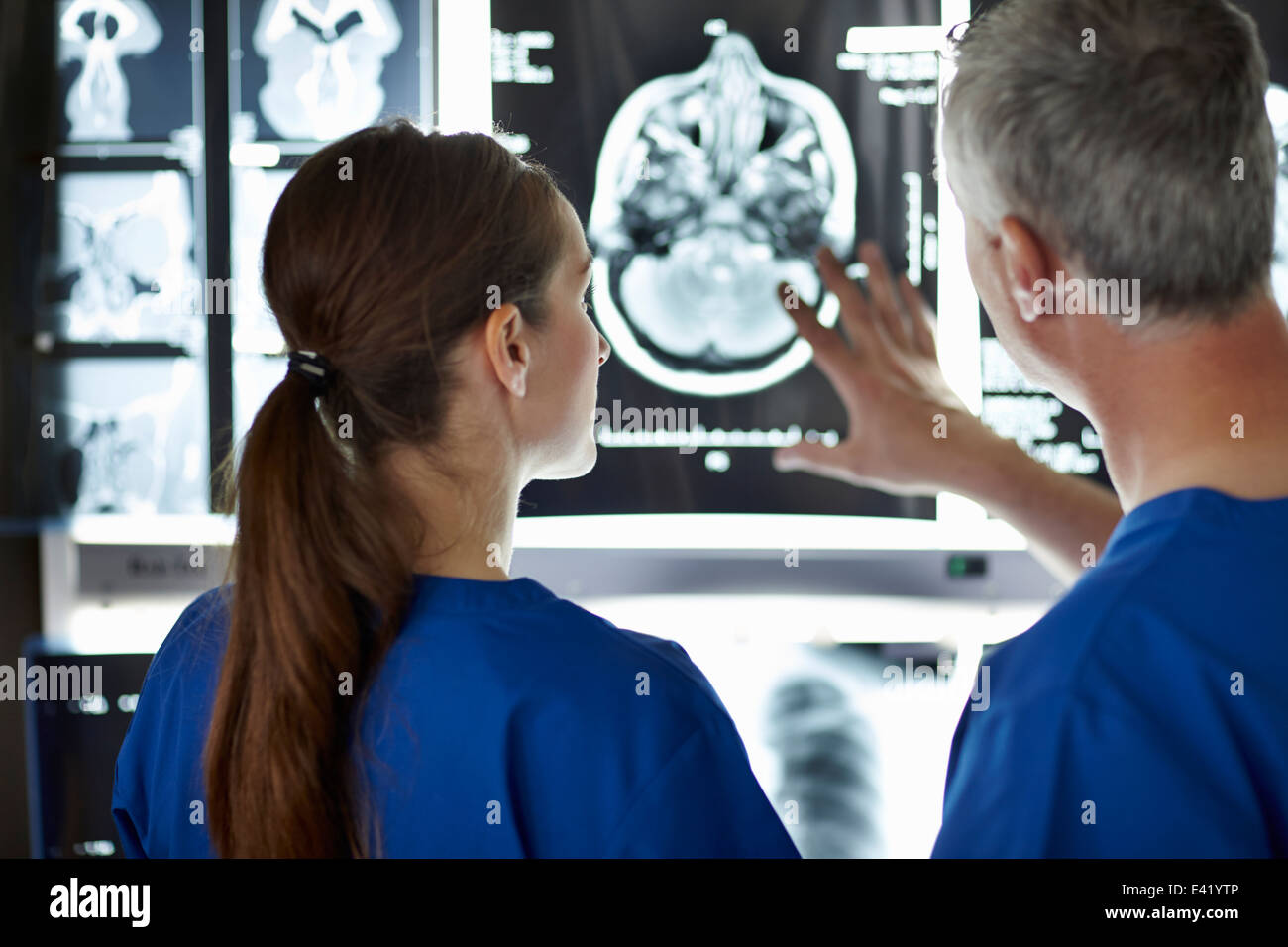 Radiologists looking at brain scans Stock Photo