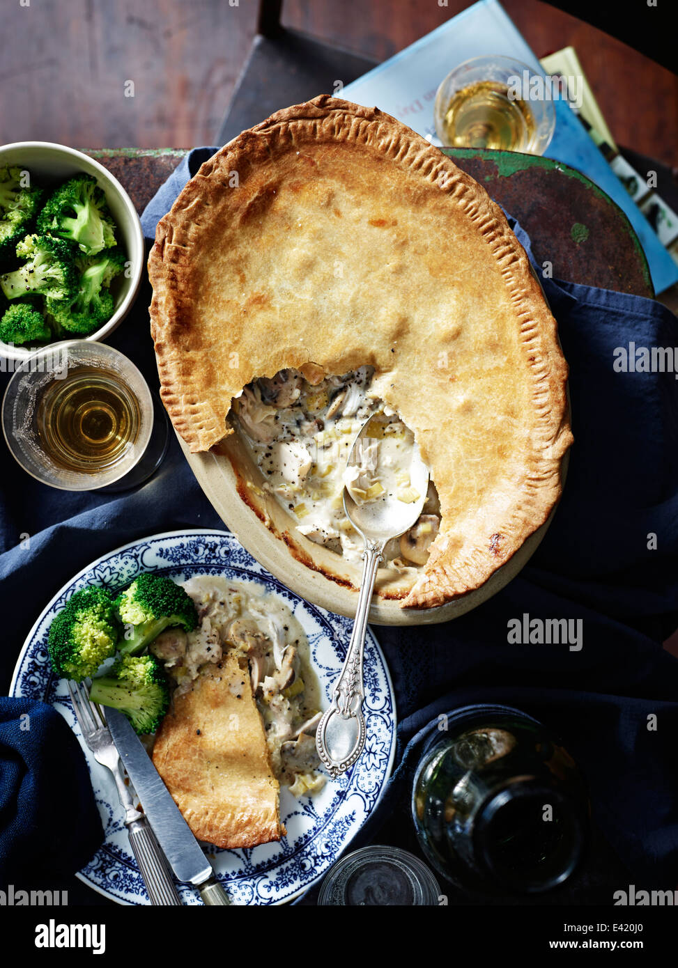 Chicken leek mushroom pie, broccoli and wine Stock Photo - Alamy