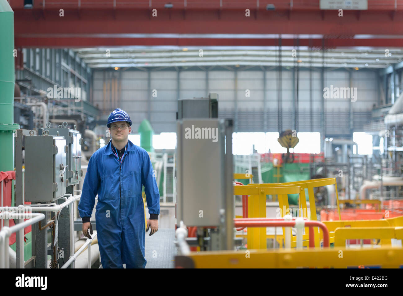 Engineer on walkway during power station outage Stock Photo