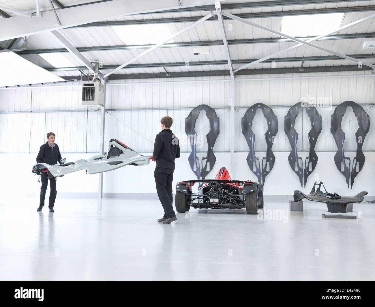 Workers preparing supercar in sports car factory Stock Photo