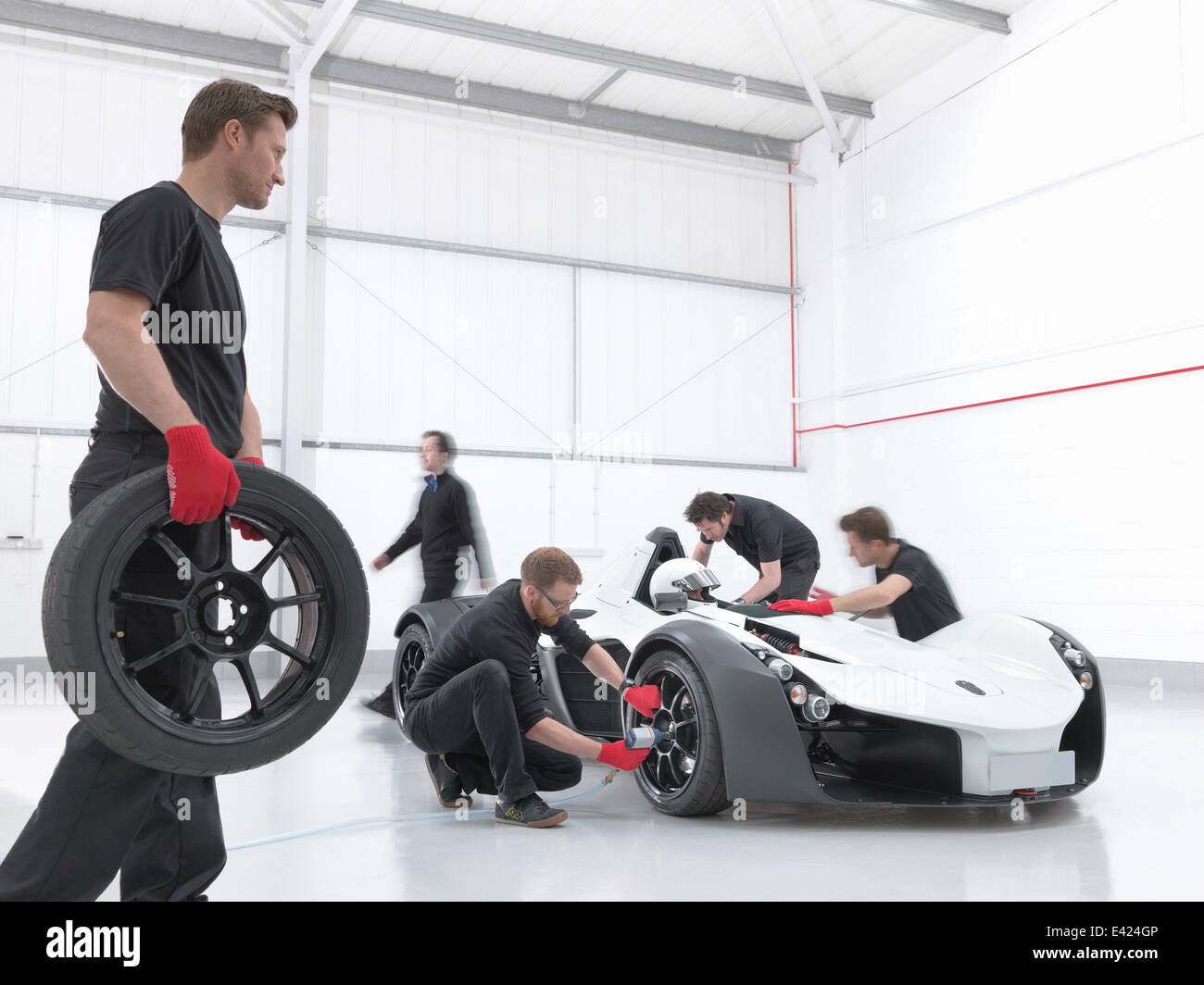 Engineers attend supercar in sports car factory Stock Photo