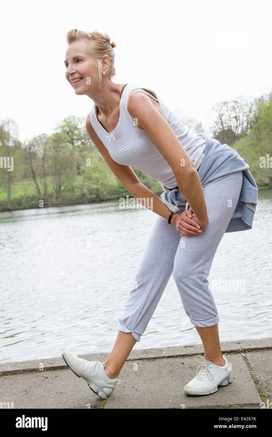 Mature woman exercising in park Stock Photo