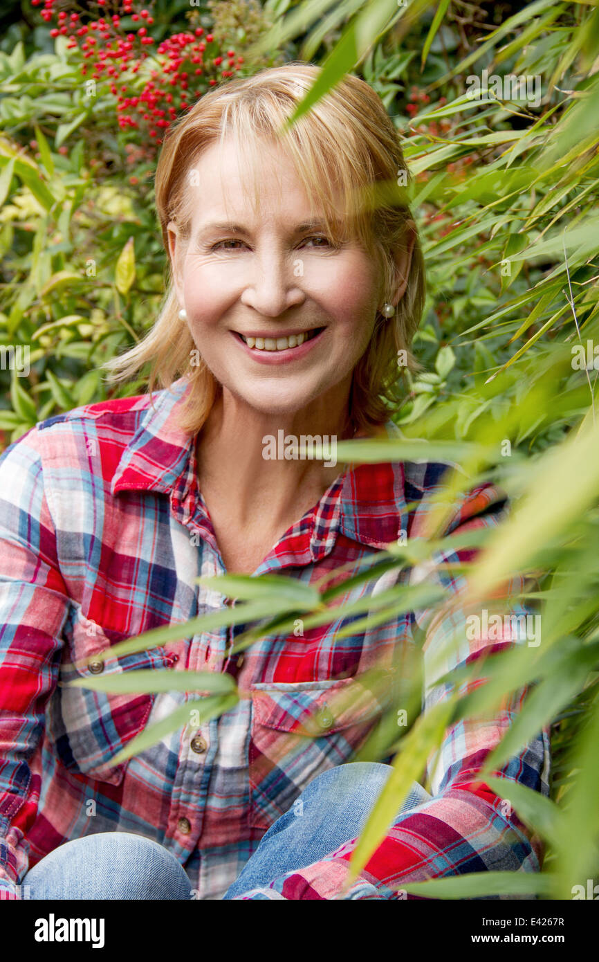 Portrait of mature woman in garden Stock Photo - Alamy