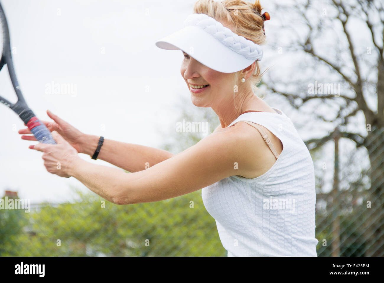 Mature female tennis player playing tennis Stock Photo