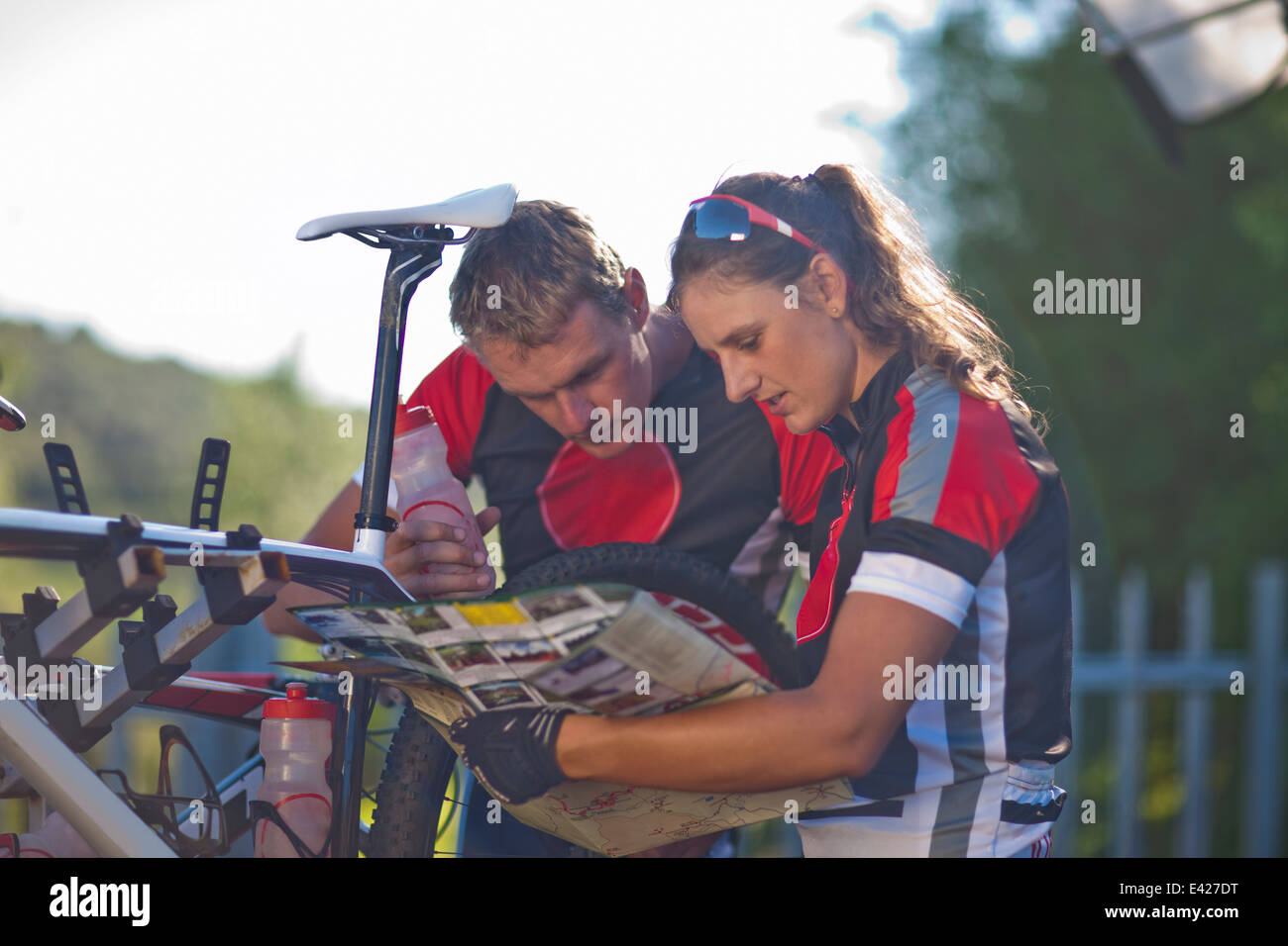 Cyclists reading map Stock Photo