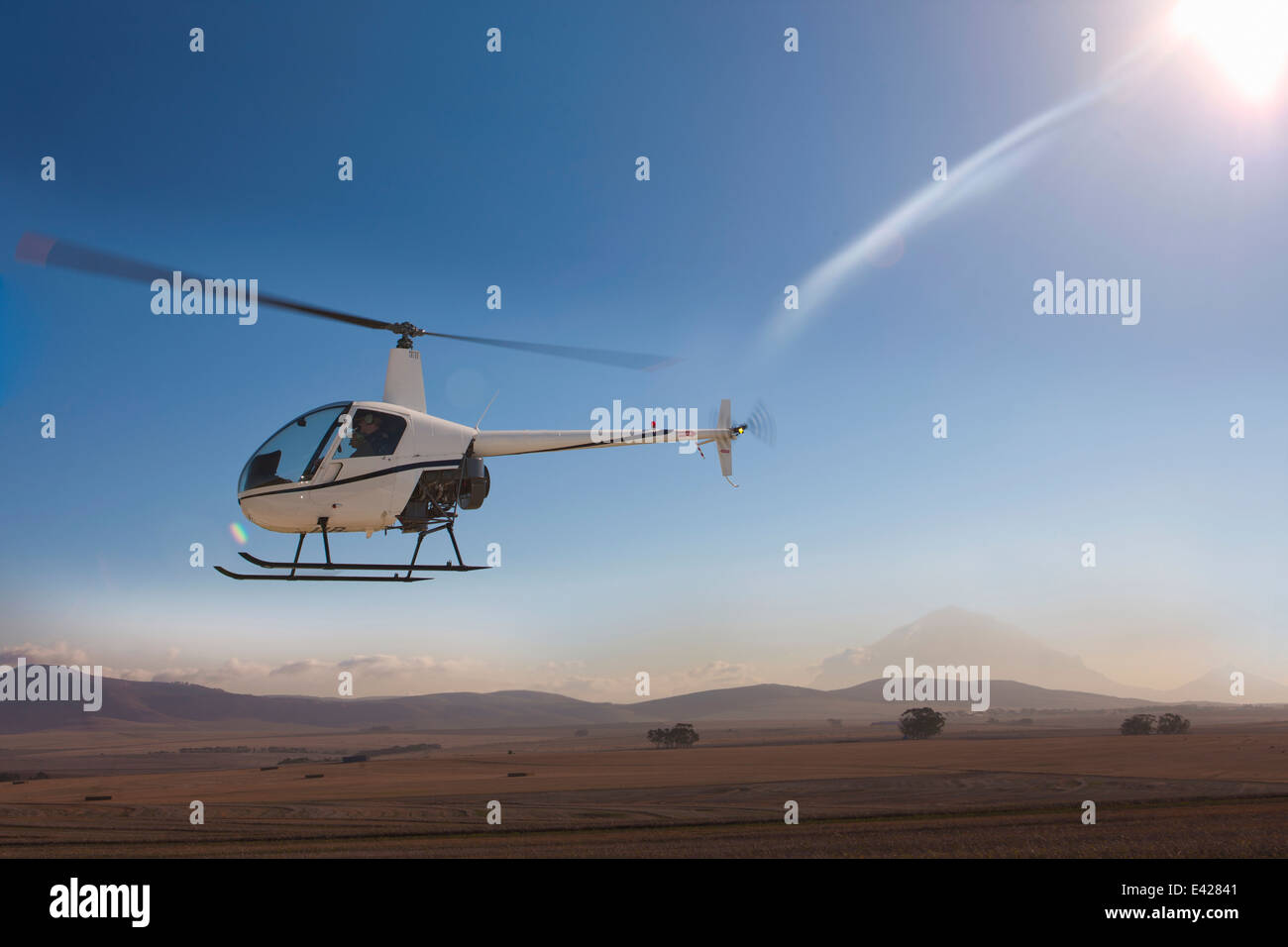 Helicopter flying close to ground Stock Photo