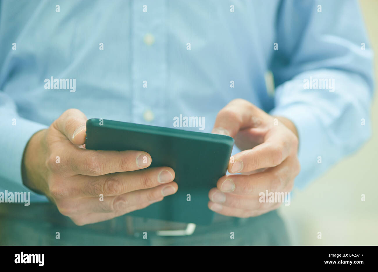 Male hands holding digital tablet Stock Photo