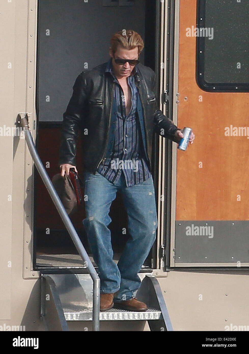 A clean shaven Johnny Depp shows a bit of paunch while leaving his ...
