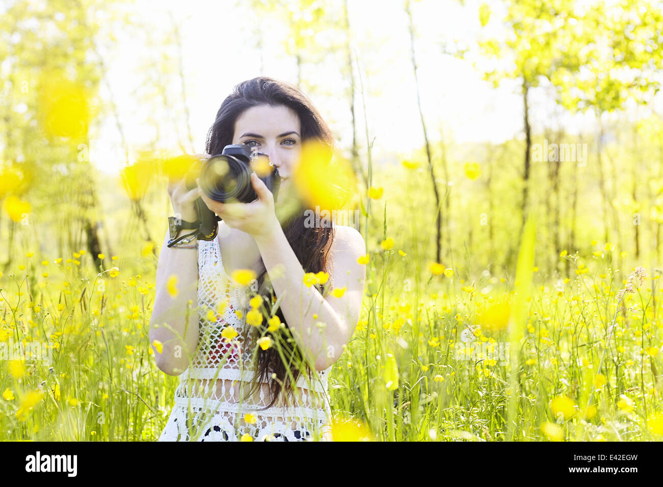 Young woman holding camera Stock Photo