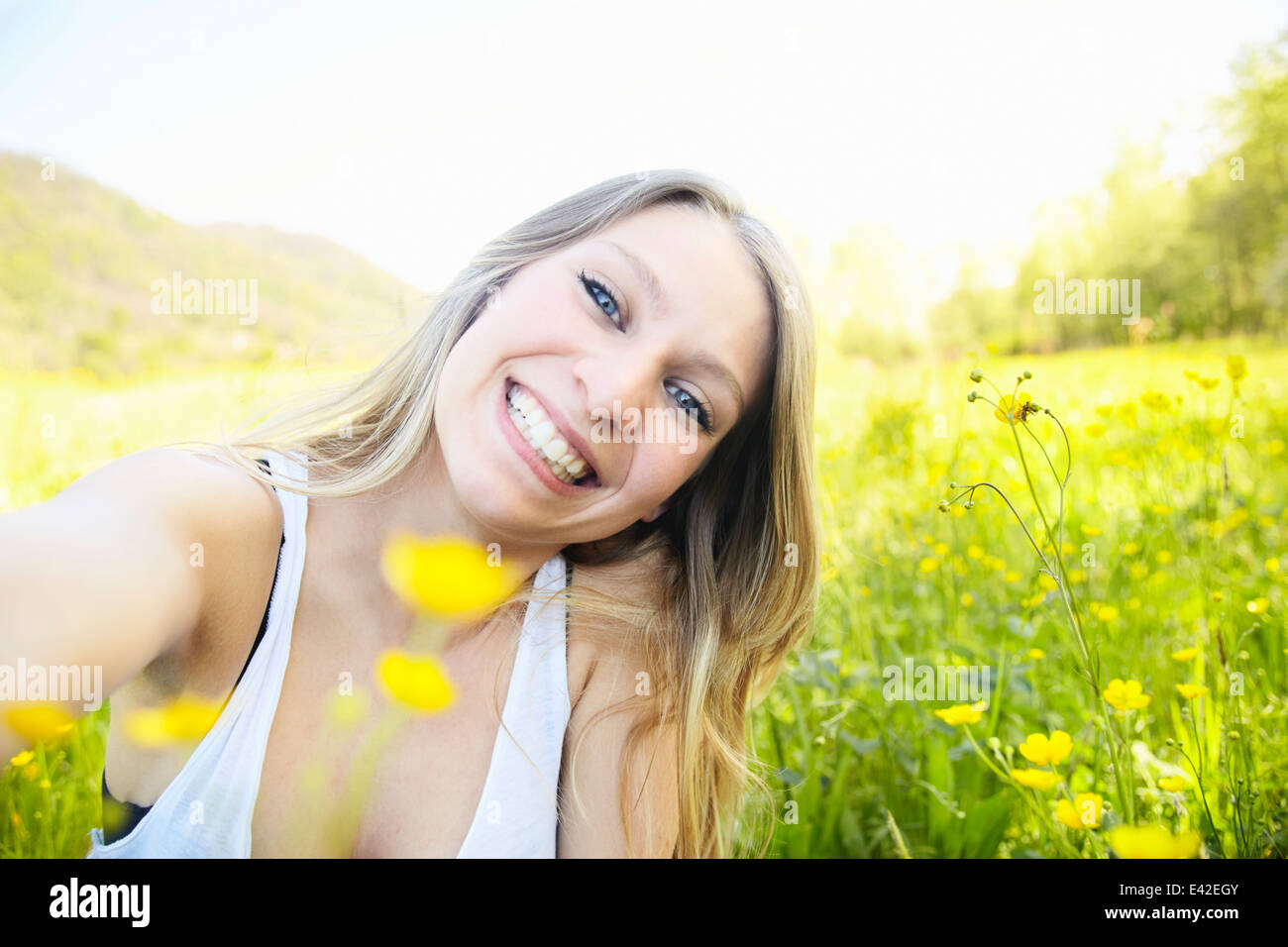 Young woman with blonde hair smiling, portrait Stock Photo