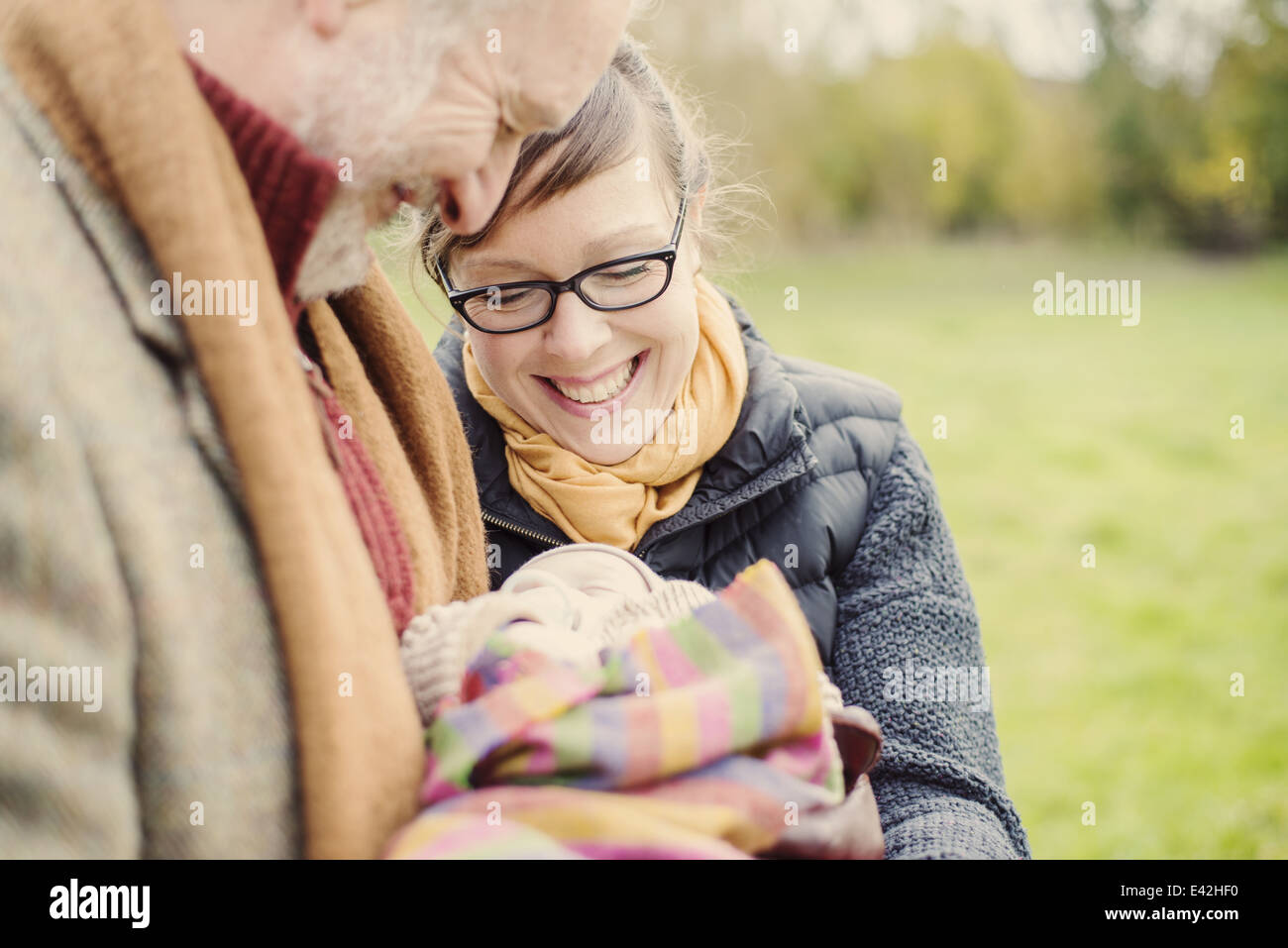 Grandfather holding grandson, with daughter Stock Photo