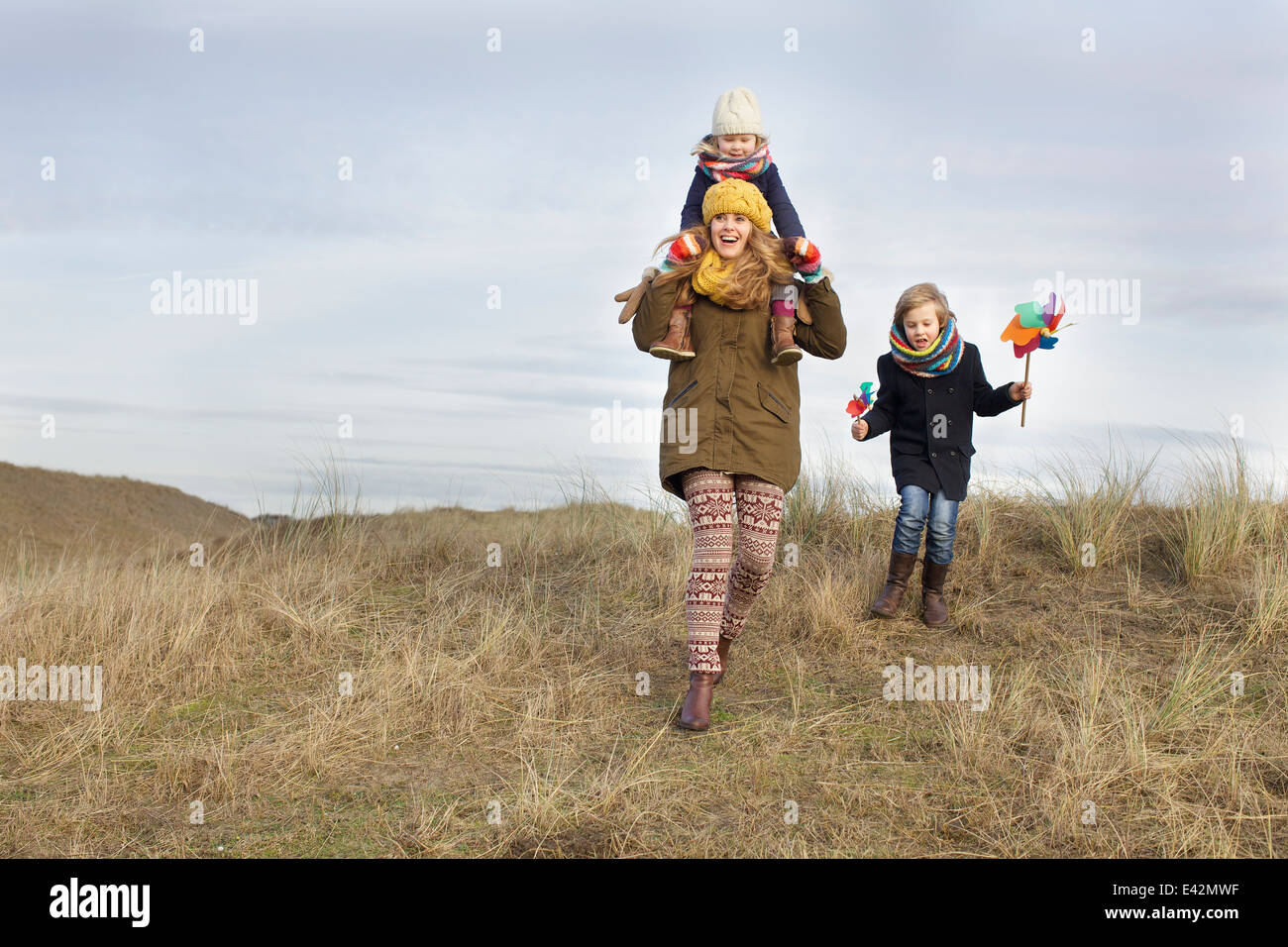 Smiling mid adult woman with daughter and son at coast Stock Photo