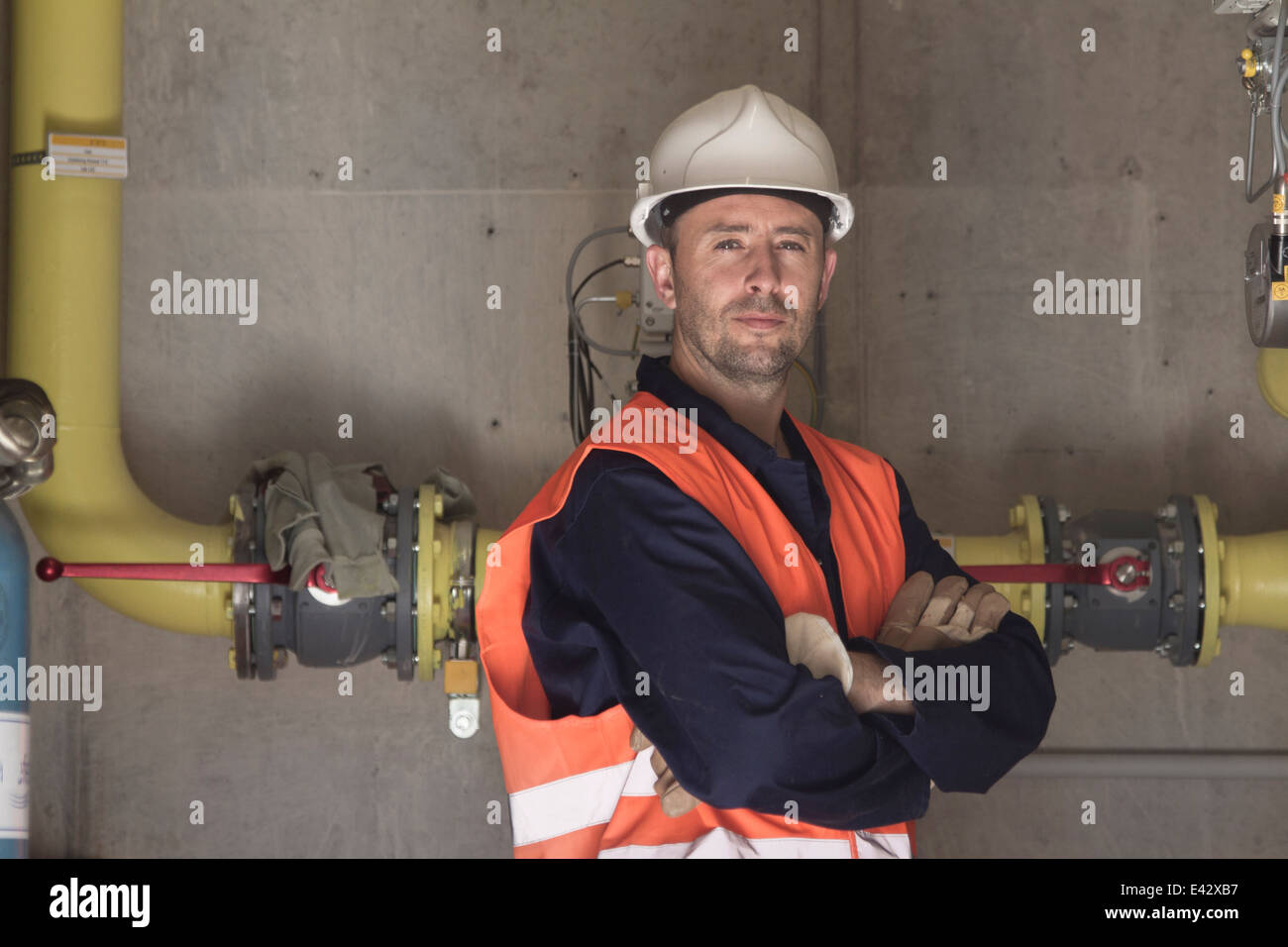 Portrait of technician with arms folded in power station Stock Photo