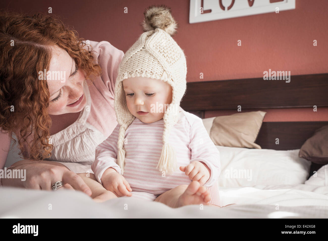 Portrait of mid adult mother and baby girl in knitted hat Stock Photo