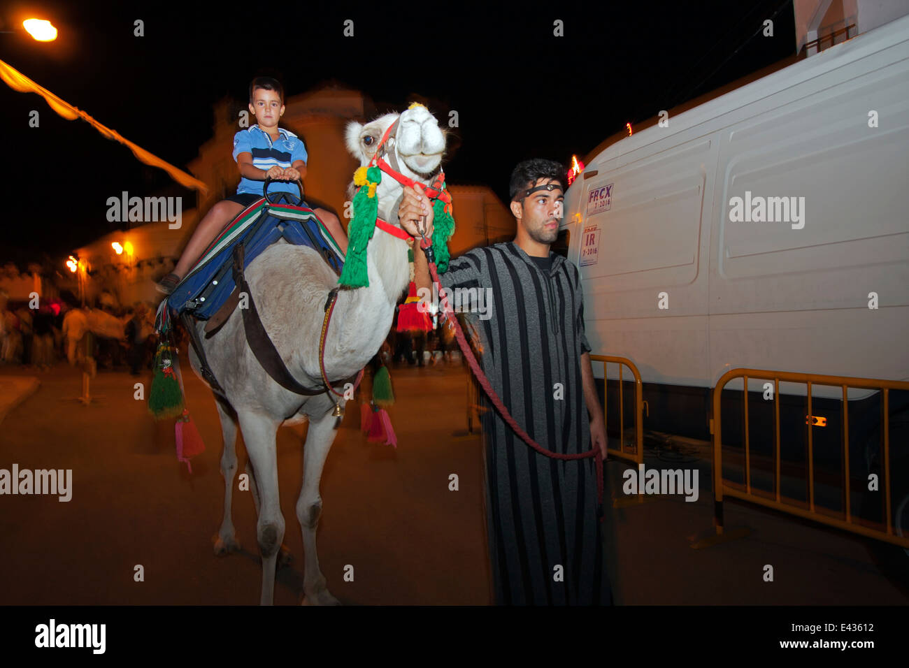 Boy riding camel hi-res stock photography and images - Alamy