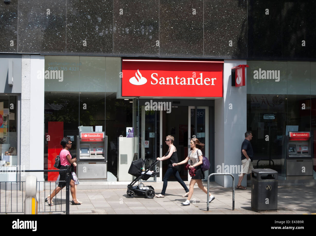 people passing a branch of the high street bank santander, chiswick, london, england Stock Photo